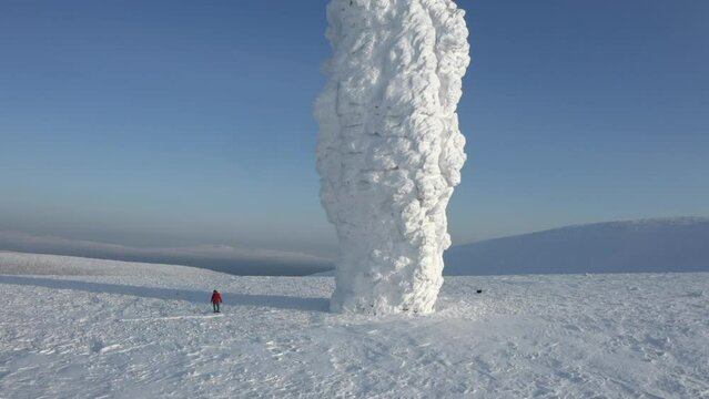 Snow covered stone blocks and white valley. Clip. Aerial view of Manpupuner in winter.
