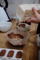 Pastry chef hands draws with a brush golden bear and horse
