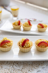 cake decoration with pastry cream and strawberry, sweet dessert, wallpaper with detailed texture in studio, gourmet food served on a plate