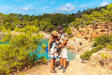 Vacation concept, A family with their child at Playa Salada and Saladeta on the coast of Ibiza. Balearic