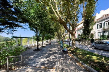 Father and his son walking in a public garden in Sintra