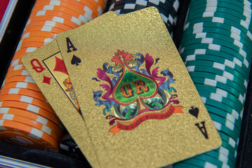 Gold playing cards and $100 bill format on poker chips