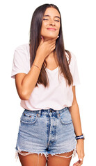 Young hispanic woman wearing casual white tshirt touching painful neck, sore throat for flu, clod and infection