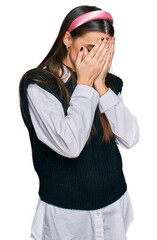 Young beautiful woman wearing casual white shirt with sad expression covering face with hands while crying. depression concept.
