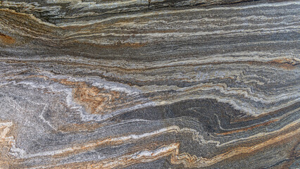 A metamorphic rock called gneiss makes pleasing patterns along its surface.
