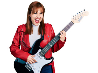 Fototapeta premium Redhead young woman playing electric guitar celebrating crazy and amazed for success with open eyes screaming excited.
