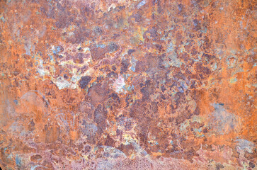Dark worn rusty metal texture or background with paint residues and rust spots.
