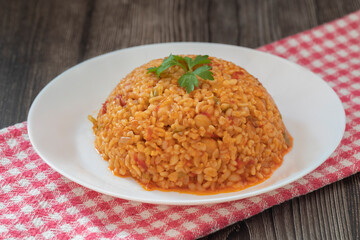 Traditional turkish bulgur pilaf with tomato sause in plate (Turkish name; meyhane pilavi)