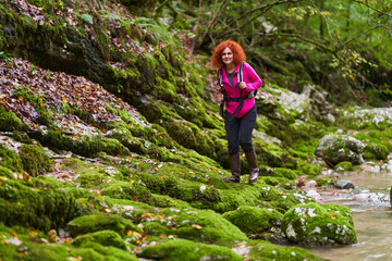 Naklejka na ściany i meble Woman hiker in the forest