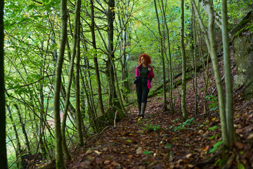 Woman nature photographer in the forest