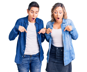 Couple of women wearing casual clothes pointing down with fingers showing advertisement, surprised face and open mouth