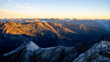 Fototapeta na wymiar Alpine mountain peaks illuminated by rising sun