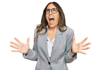 Young brunette woman wearing business clothes crazy and mad shouting and yelling with aggressive...