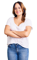 Young beautiful caucasian woman wearing casual white tshirt happy face smiling with crossed arms...