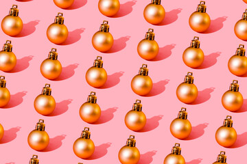 Fototapeta na wymiar christmas ball gold pattern on light pink background medium ball