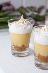 details of glass cup with coffee and cream as decoration, sweet drink as appetizer in studio, exquisite sweets
