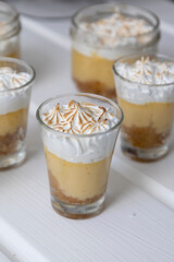 details of cups with candy on a decorated table, gourmet food as an appetizer, catering service ready for celebration