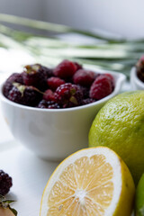 bowl with citrus fruit with vitamin c, healthy diet in studio, delicious and natural food as blackberry and lemon wallpaper