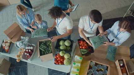 Top View. The Concept of Social Aid: Cute Young Boy Help to Volunteers to Sorting Humanitarian Aid at Distribution or Refugee Assistance Center. Charity, Donation, and Volunteering Concept.