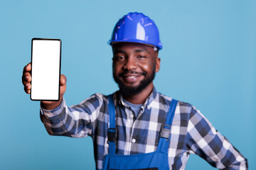African american man holding cellphone with blank screen for advertising in front of camera....
