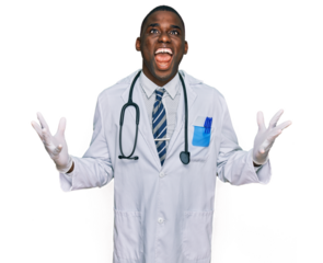 Young african american man wearing doctor uniform and stethoscope crazy and mad shouting and yelling with aggressive expression and arms raised. frustration concept.