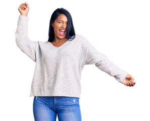 Hispanic woman with long hair wearing casual clothes dancing happy and cheerful, smiling moving casual and confident listening to music