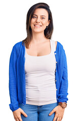 Obraz premium Young beautiful woman wearing casual clothes looking positive and happy standing and smiling with a confident smile showing teeth