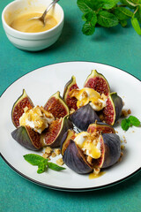 Figs stuffed with cream cheese with honey sauce and walnuts