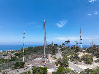 Aerial view of telecommunication tower with 5G cellular network antenna on the top of a valley in...