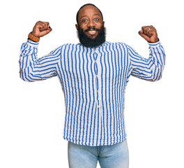 Young african american man wearing business shirt showing arms muscles smiling proud. fitness concept.