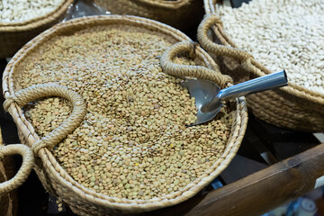 Closeup of raw lentil grains in basket on grocery shop display. Concept of natural food