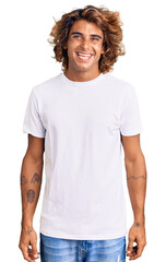 Young hispanic man wearing casual white tshirt with a happy and cool smile on face. lucky person.
