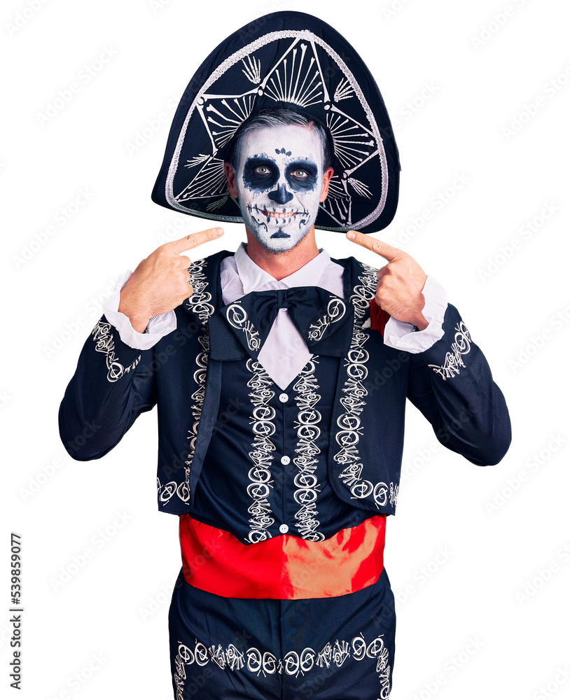 Sticker young man wearing day of the dead costume over background smiling cheerful showing and pointing with