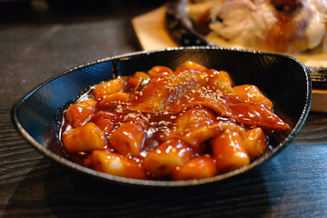 Tteokbokki is a popular Korean snack food. It's made from soft rice cake, fish cake and sweet red chili sauce