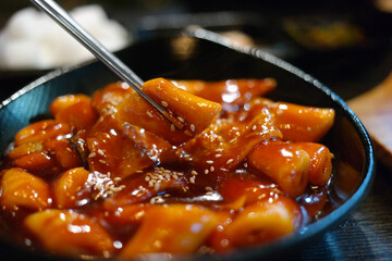 Tteokbokki is a popular Korean snack food. It's made from soft rice cake, fish cake and sweet red chili sauce