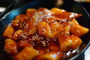 Tteokbokki is a popular Korean snack food. It's made from soft rice cake, fish cake and sweet red chili sauce