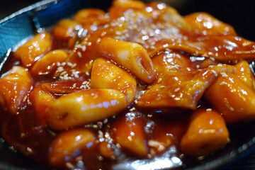 Tteokbokki is a popular Korean snack food. It's made from soft rice cake, fish cake and sweet red chili sauce