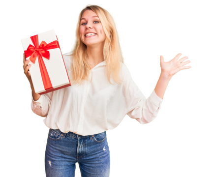 Young beautiful blonde woman holding gift annoyed and frustrated shouting with anger, yelling crazy with anger and hand raised - Powered by Adobe