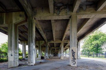 Under a dingy bridge with graffiti 