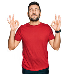 Young hispanic man wearing casual clothes relax and smiling with eyes closed doing meditation gesture with fingers. yoga concept.