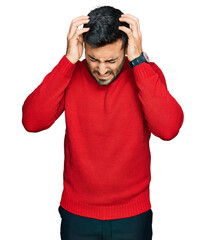 Young hispanic man wearing casual clothes suffering from headache desperate and stressed because pain and migraine. hands on head.