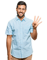 Handsome hispanic man wearing casual clothes showing and pointing up with fingers number four while...