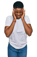 Fototapeta premium Young african american woman wearing casual white t shirt with hand on head, headache because stress. suffering migraine.