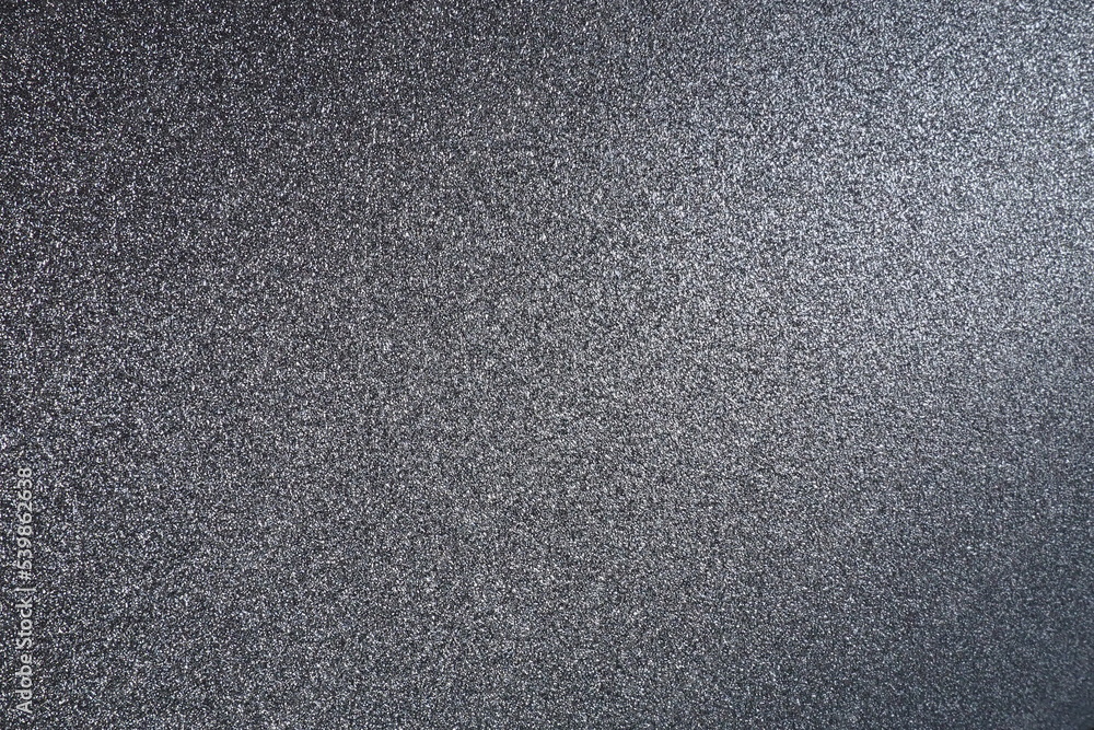 Poster black or dark gray background with glitter. texture of rough paper or cardboard. defocused bokeh spa
