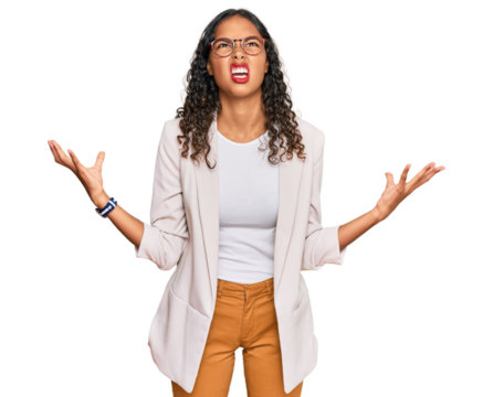 Young african american girl wearing business clothes crazy and mad shouting and yelling with aggressive expression and arms raised. frustration concept.
