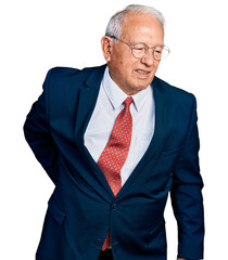 Senior man with grey hair wearing business suit and glasses suffering of backache, touching back...