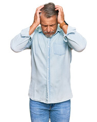 Middle age grey-haired man wearing casual clothes suffering from headache desperate and stressed...