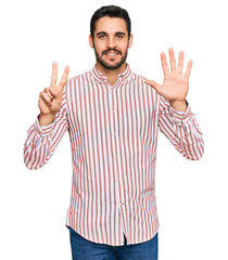 Young hispanic man wearing business shirt showing and pointing up with fingers number seven while smiling confident and happy.