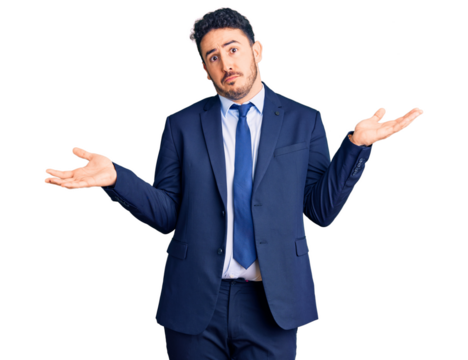 Young hispanic man wearing business clothes clueless and confused expression with arms and hands raised. doubt concept.