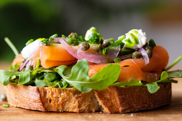 Open sandwich with smoked salmon, pickled onions, sour cream and capers